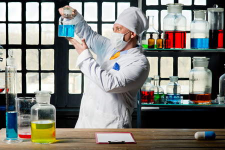 Scientist chemist puts science experiment in laboratoryの写真素材