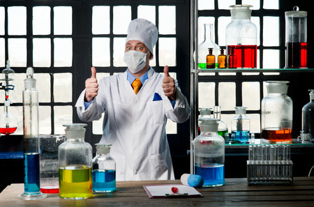 Scientist chemist puts science experiment in laboratoryの写真素材