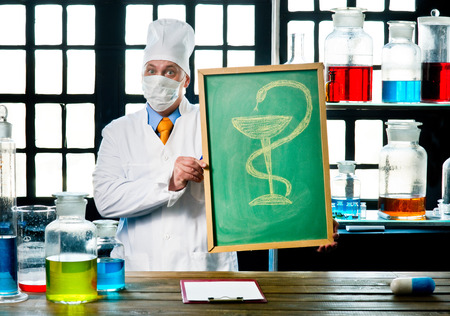 Scientist chemist with blackboard in laboratoryの写真素材