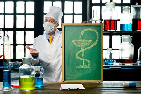 Scientist chemist with blackboard in laboratory の写真素材