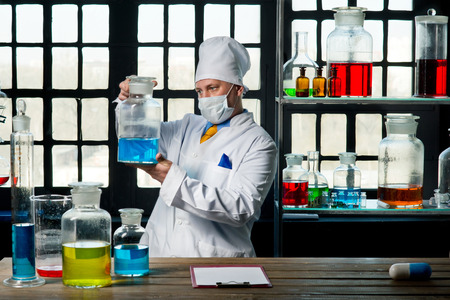 Scientist chemist puts science experiment in laboratoryの写真素材