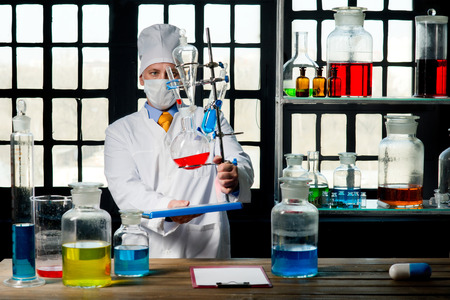 Scientist chemist puts science experiment in laboratoryの写真素材