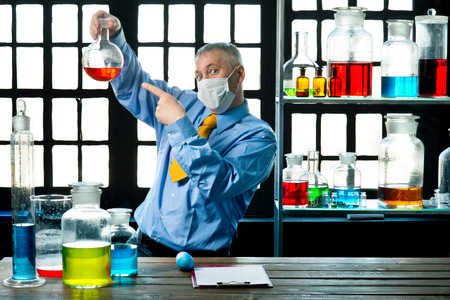Scientist chemist puts science experiment in laboratoryの写真素材