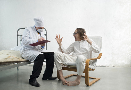 Doctor and crazy patient in a hospitalの写真素材