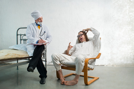 Doctor and crazy patient in a hospitalの写真素材