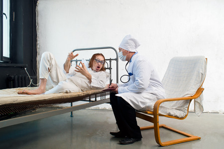 Doctor and bizarre patient in a hospitalの写真素材