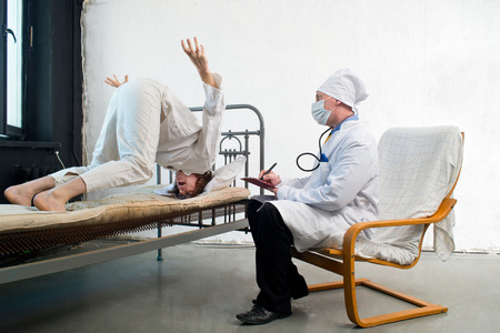 Doctor and crazy patient in a hospitalの写真素材