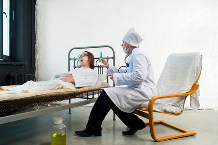 Doctor and infirm patient in a hospitalの写真素材