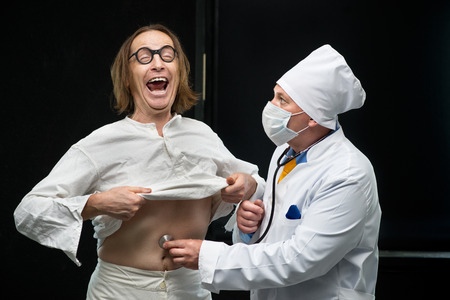 Doctor listens to a stethoscope the patientの写真素材