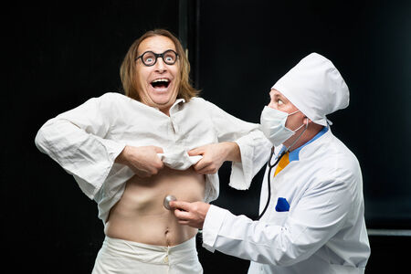 Doctor listens to a stethoscope the patientの写真素材