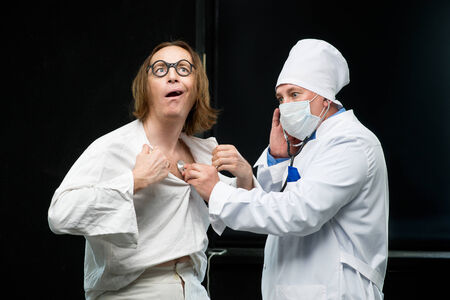 Doctor listens to a stethoscope the patientの写真素材