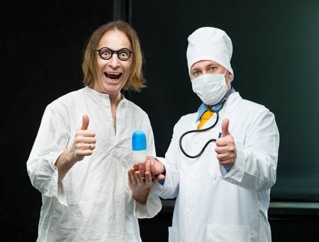 Patient takes the pill out of the hands of the doctorの写真素材