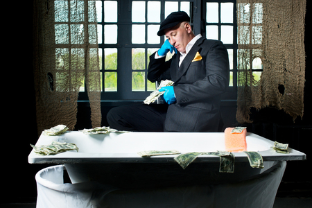 Man money launderers in the bathの写真素材