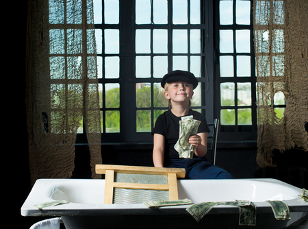 Little boy holds the laundered moneyの写真素材