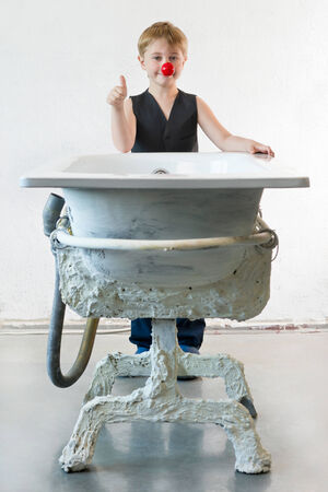 Boy stands near a art bathの写真素材