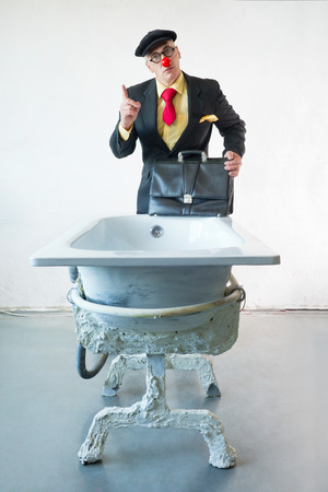 Man in suit stands near a art bathの写真素材