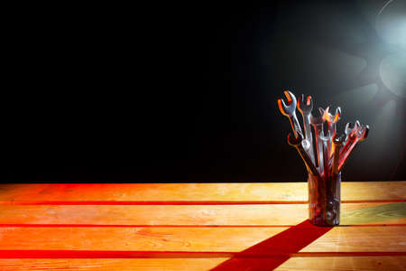 Set of wrenches on the wooden table in bright lightの写真素材