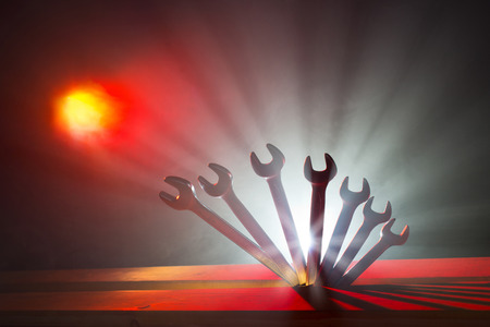 Set of wrenches on the wooden table in bright light 