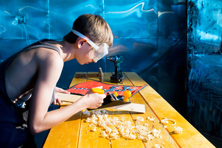 Young carpenter at work in the workshopの写真素材