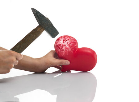 The blow of a hammer on heartの写真素材