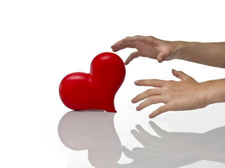 Hands and heart on the white backgroundの写真素材