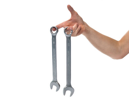 Two wrenches in the hand on the white backgroundの写真素材