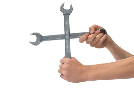 Two wrenches in the hands on the white backgroundの写真素材