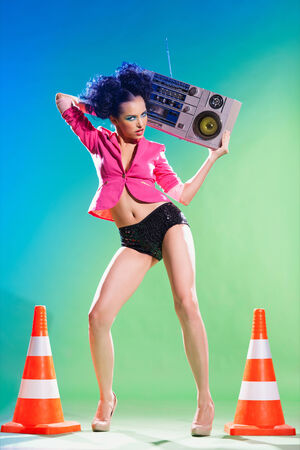 Merry girl with a tape recorder on the discoの写真素材