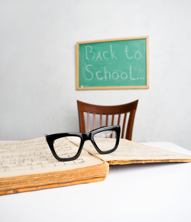 Glasses and music book on the table in the classroomの写真素材