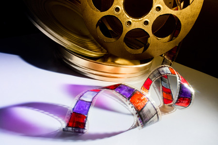 Golden reel of film on a color backgroundの写真素材