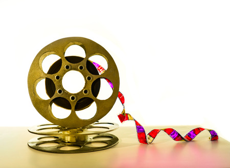 Gold reel of film on a white backgroundの写真素材