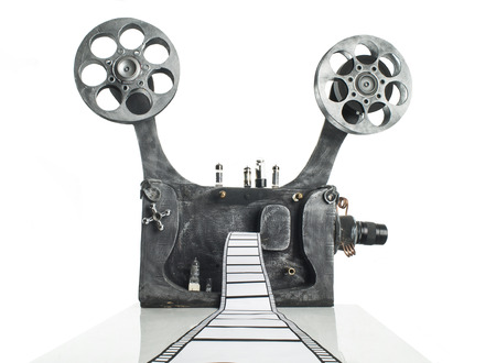 Movie projector with the film on the white backgroundの写真素材
