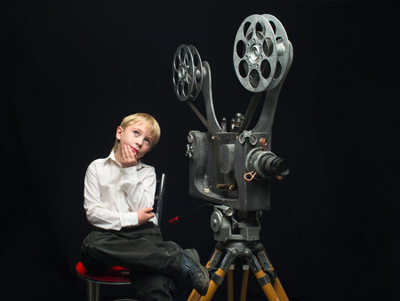 Little boy with a film projectorの写真素材