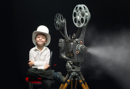 Little boy with a film projectorの写真素材