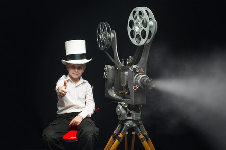 Little boy with a film projectorの写真素材