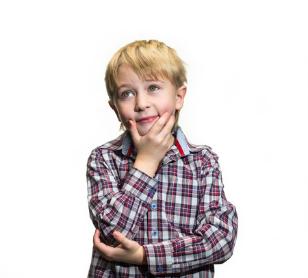 Portrait of daydreaming boy on a white backgroundの写真素材