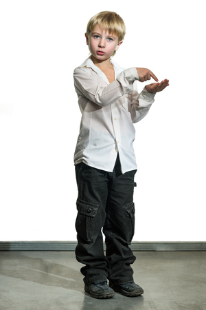 Naughty child in grubby clothesの写真素材