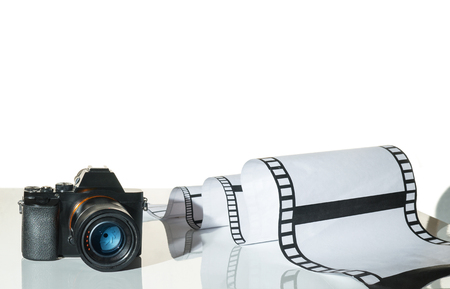 Camera and film on a tableの写真素材