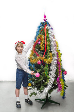 Little Santa near the Christmas treeの写真素材