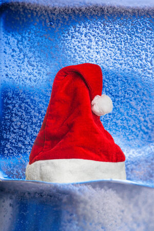 Hat of Santa Claus on the snowの写真素材