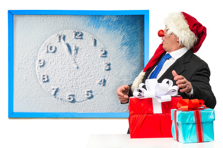 Santa Claus with gifts near the blackboardの写真素材