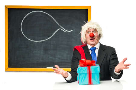 Santa Claus with gifts near the blackboardの写真素材