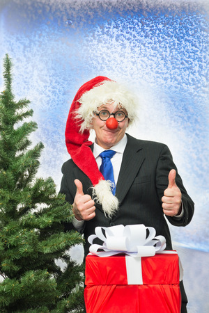 Cheerful Santa Claus with a gifts near the treeの写真素材