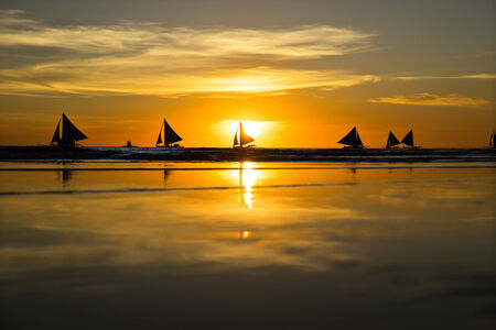 Boat trip at sunset under sailの写真素材
