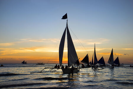 Boat trip at sunset under sailの写真素材
