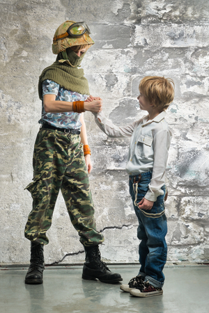 Young soldier and boy  shake handsの写真素材