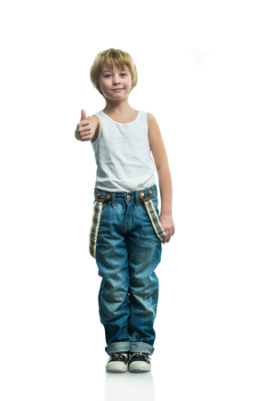 Smiling boy in jeans on the white backgroundの写真素材