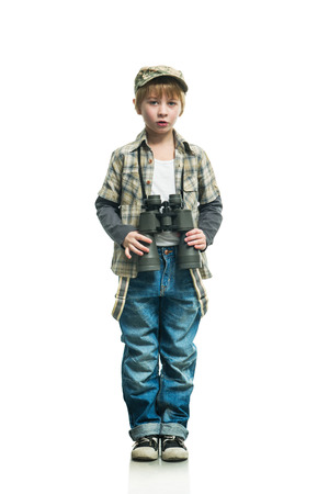 Little boy in a jeans with a binocularsの写真素材
