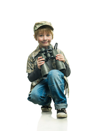 Little boy in a jeans with a binocularsの写真素材