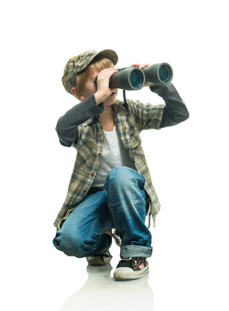 Little boy in a jeans with a binocularsの写真素材